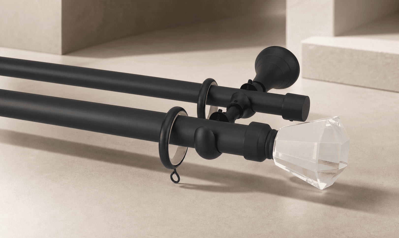 Matte black decorative drapery hardware with rings, bracket, and crystal finial