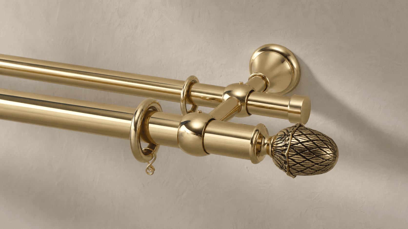 Brass fixed decorative curtain rod shown on a warm neutral background